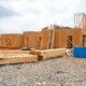 a wooden house being built using low carbon adhesives for construction